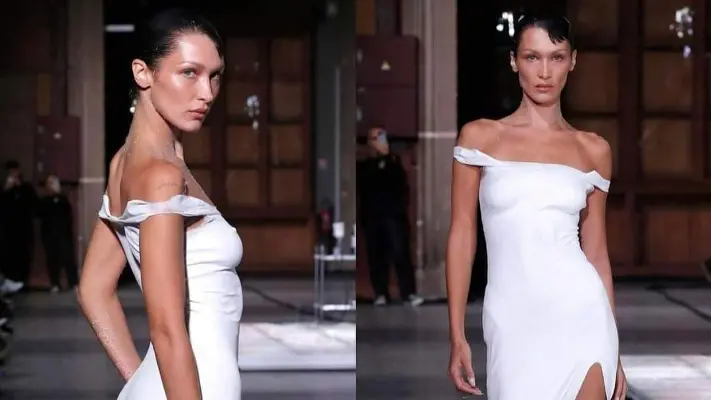 بيلا حديد شبه عارية لـ صناعة فستان لها من الرذاذ الأبيض - فيديو